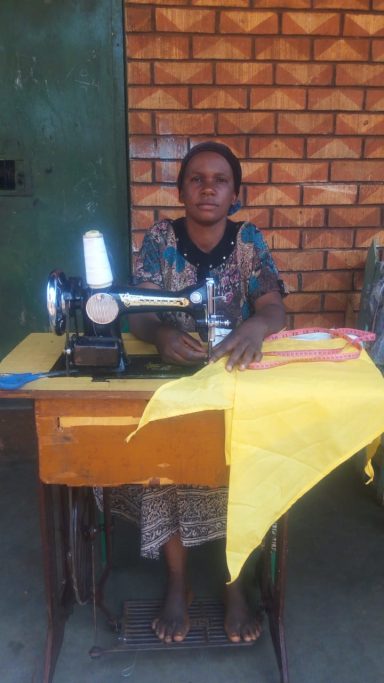 OHEC Mrs. Musana Making School Uniforms