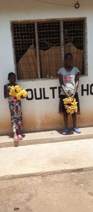 Helen and Eunice holding bananas