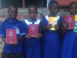 Students with new uniforms & Bibles